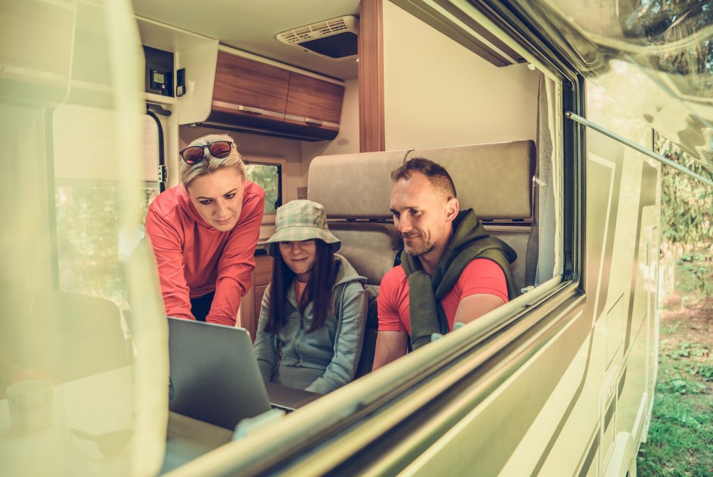 family watching movies on a laptop in their RV that smells fresh 