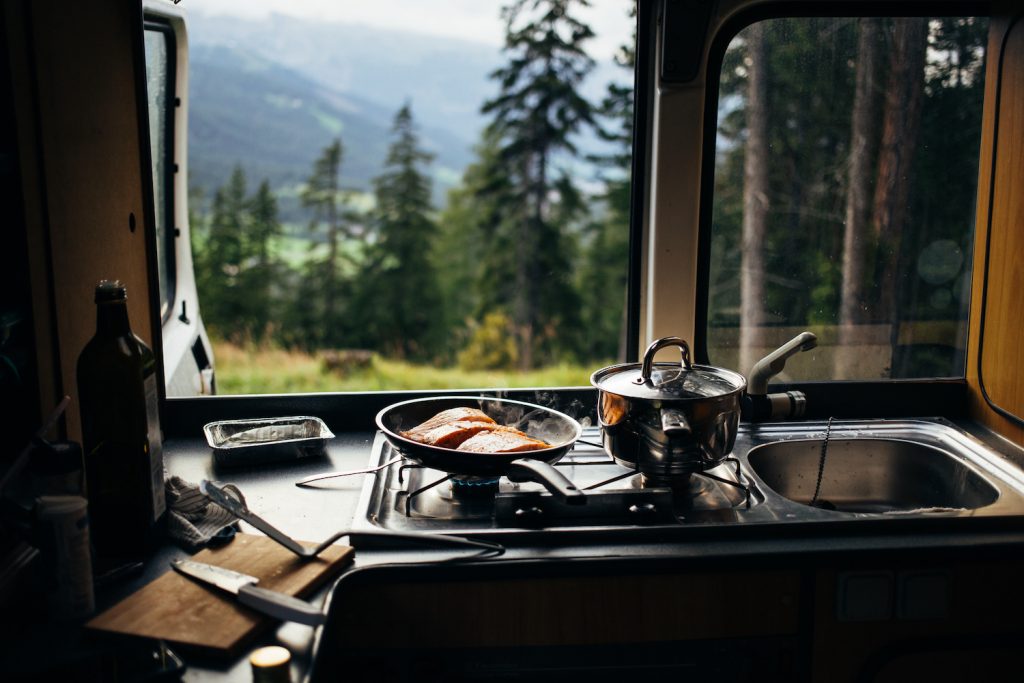 RV camping recipes make eating on the campsite easy, like this salmon being cooked in an RV kitchen